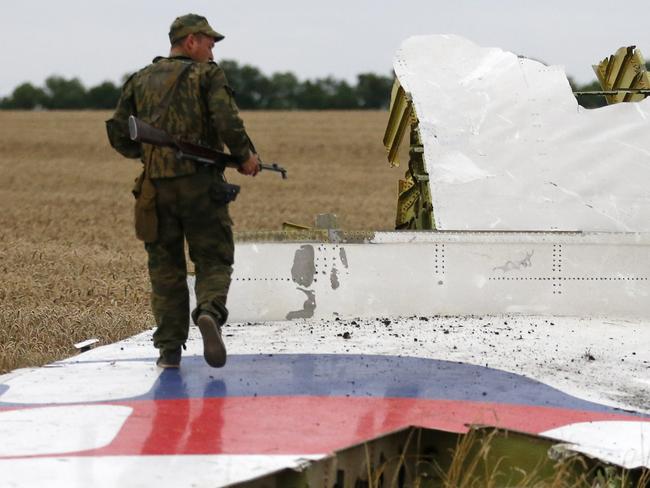 An armed pro-Russian separatist stands on part of the wreckage of the Malaysia Airlines Boeing 777 plane after it crashed near the settlement of Grabovo in the Donetsk region, July 17, 2014. The Malaysian airliner flight MH17 was brought down over eastern Ukraine on Thursday, killing all 295 people aboard and sharply raising stakes in a conflict between Kiev and pro-Moscow rebels in which Russia and the West back opposing sides. MUST CREDIT © Maxim Zmeyev/ Reuters Pictures / Picture Media.