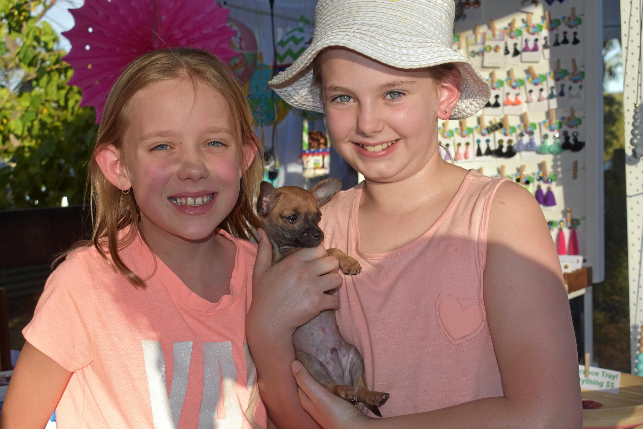 Thelma Stromblae and Lucia Badgely make friends with 8-week-old Bouncer. Picture: Ellen Ransley