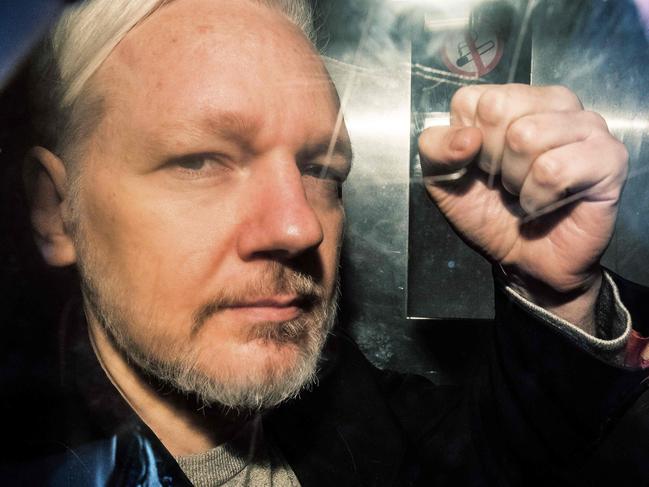 WikiLeaks founder Julian Assange gestures from the window of a prison van as he is driven into Southwark Crown Court in London on May 1. Picture: AFP 