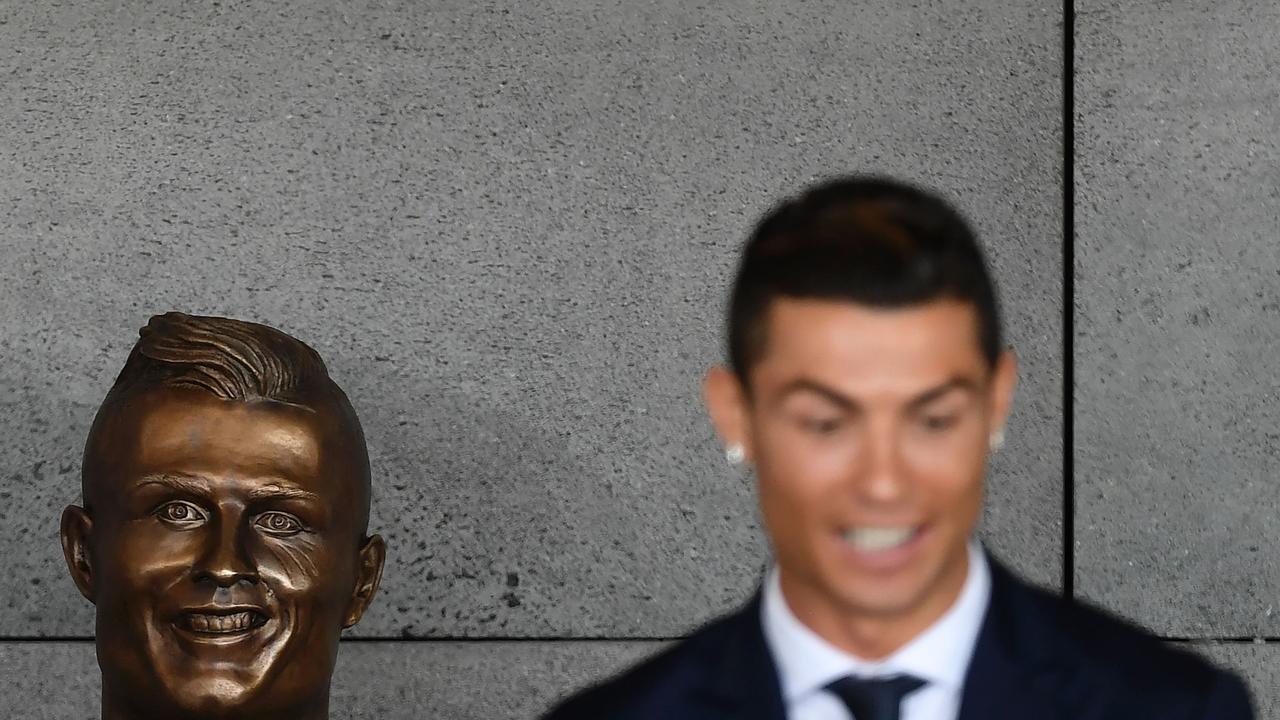 Cristiano Ronaldo with his ‘statue’. Picture: AFP.