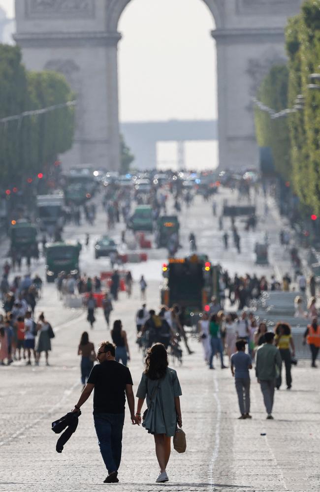 Pedestrians walk on Champs-Elysees avenue in Paris a day after protesters took to the iconic street and clashed with police. Picture: AFP