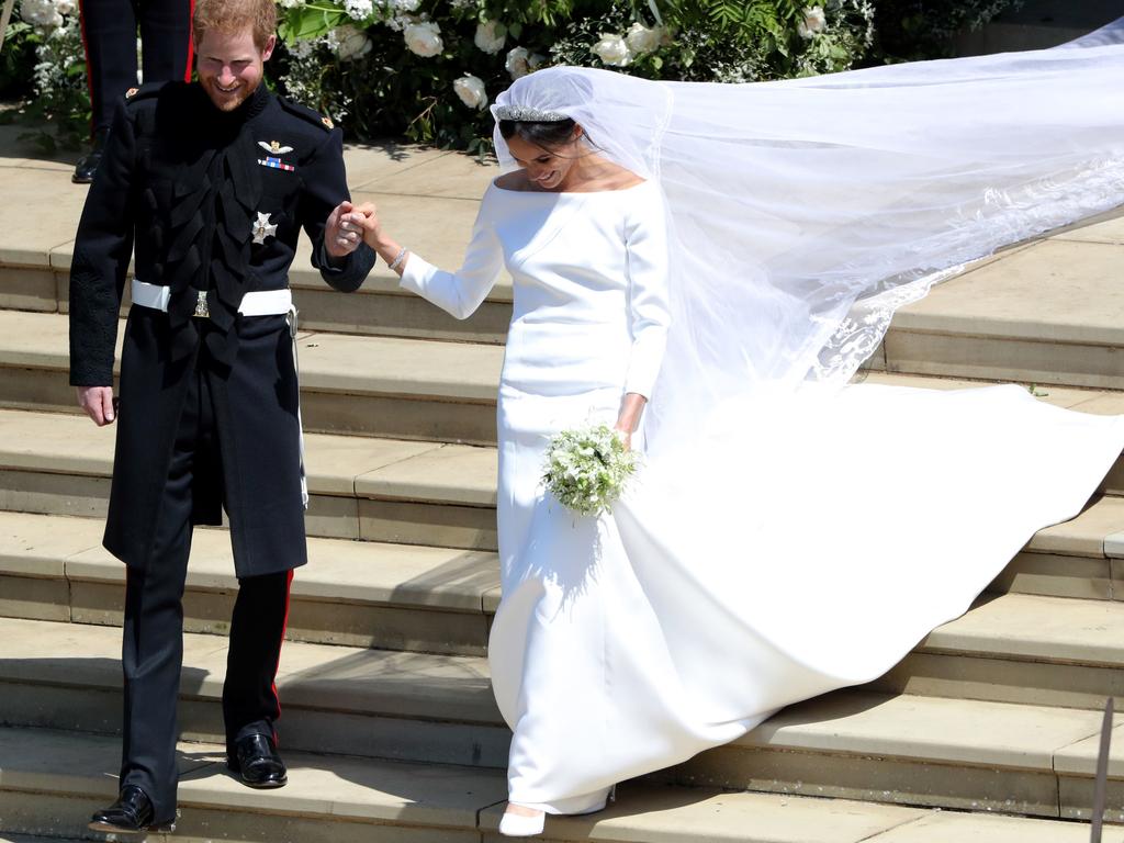 Britain's Prince Harry, Duke of Sussex and his wife Meghan, Duchess of Sussex leave from the West Door of St George's Chapel, Windsor Castle, in Windsor, on May 19, 2018 after their wedding ceremony. Picture: AFP PHOTO / POOL / Andrew Matthews