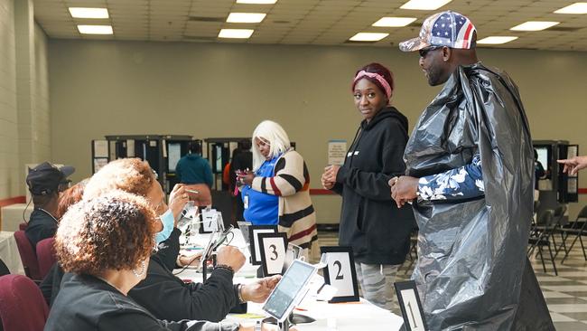 Derek Stevenson wears a garbage bag and a Trump hat to cast his vote at the C.T. Martin polling place in Atlanta, Georgia.