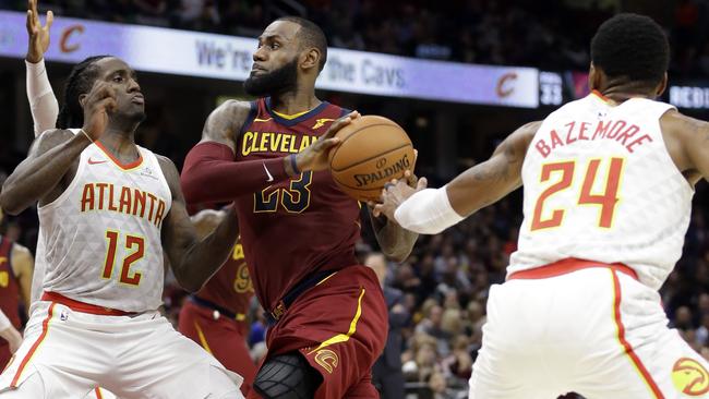 Cleveland Cavaliers' LeBron James drives against Atlanta Hawks' Taurean Prince.