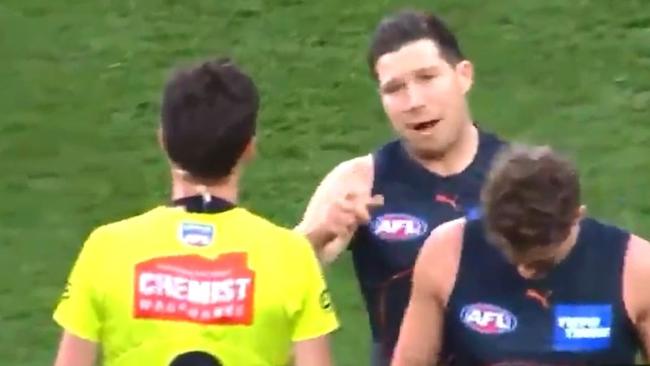 GWS star Toby Greene walks towards and bumps umpire Matt Stevic in a 2021 final.