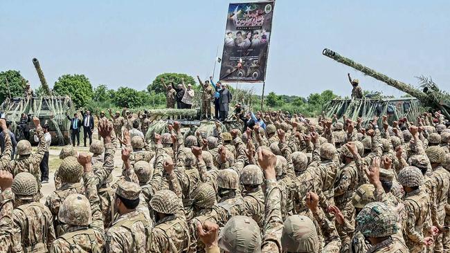 Pakistan Prime Minister Shehbaz Sharif stands on a tank amid army personnel chanting slogans. Picture: Pakistan's Inter Services Public Relations/AFP