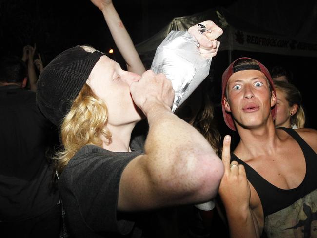 Teenagers drinking out of a goon bag. Schoolies Sunday night, Main Beach Park, Byron Bay 2012. Drinking, alcohol, teens, youth, generic.