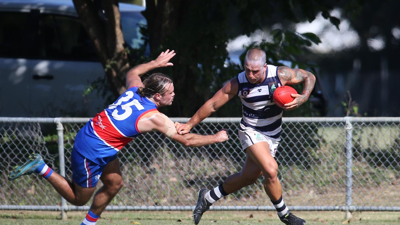 Liam Brandt palms off Jack Taylor in the AFL Cairns seniors match between Centrals Trinity Beach Bulldogs and Port Douglas Crocs. Picture: Brendan Radke