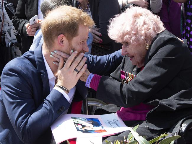 Harry is embraced by war widow Daphne Dunn, 98, outside the Opera House. Picture: AP