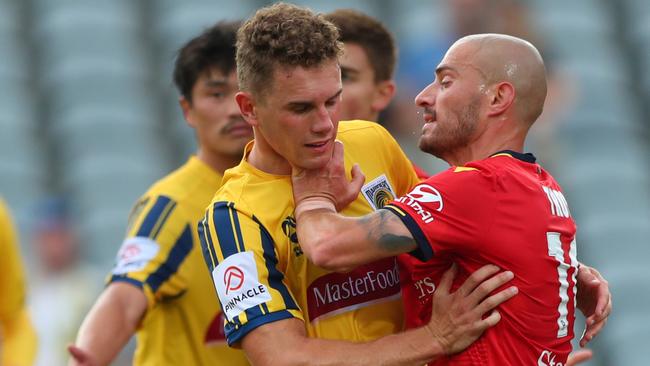 Adelaide’s James Troisi gets up close and personal with Central Coast’s Gianni Stensness. Picture: Tony Feder/Getty Images