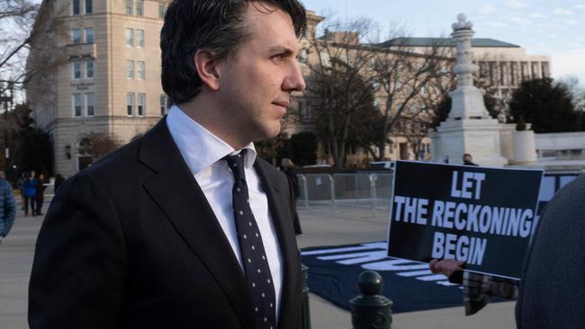 Jason Murray, the lead lawyer for the Colorado voters in the lawsuit, walks past anti-Trump demonstrators outside the US Supreme Court. Picture: Roberto Schmidt / AFP