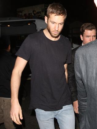 A rather grumpy looking Calvin Harris partied with his girlfriend and gal pals. Picture: Splash News Australia