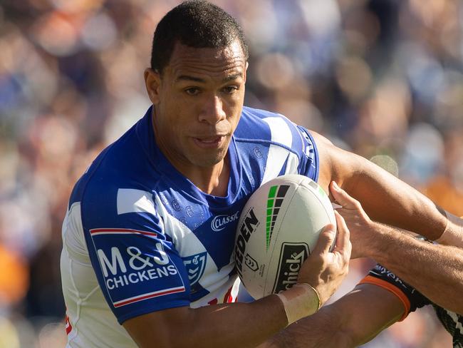 Bulldogs William Hopoate gets tackled by Tigers Corey Thompson during the Tigers and Canterbury Bulldogs round 3 match at Campbelltown Stadium, Sydney, Sunday, March 31, 2019. (AAP Image/Steve Christo) NO ARCHIVING, EDITORIAL USE ONLY