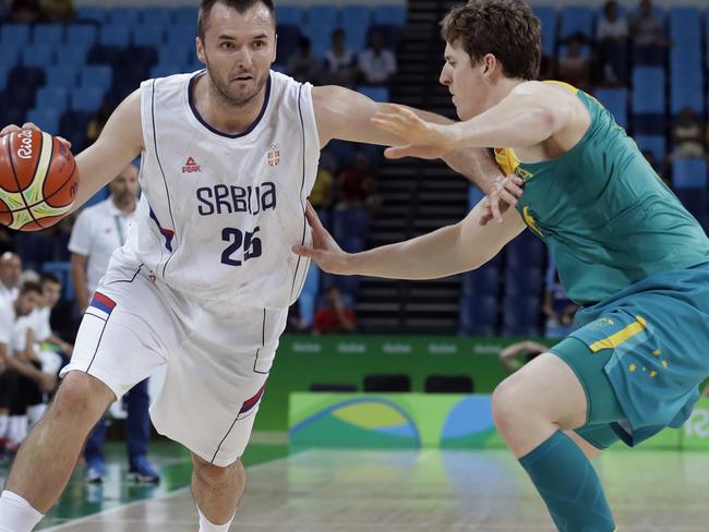 Serbia's Milan Macvan (25) drives past Australia's Cameron Bairstow, right, during a basketball game at the 2016 Summer Olympics in Rio de Janeiro, Brazil, Monday, Aug. 8, 2016. (AP Photo/Charlie Neibergall)