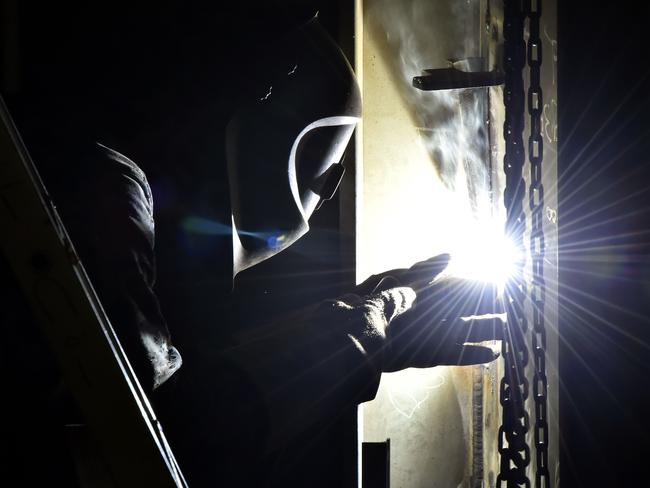 A technician works with a soldering iron.