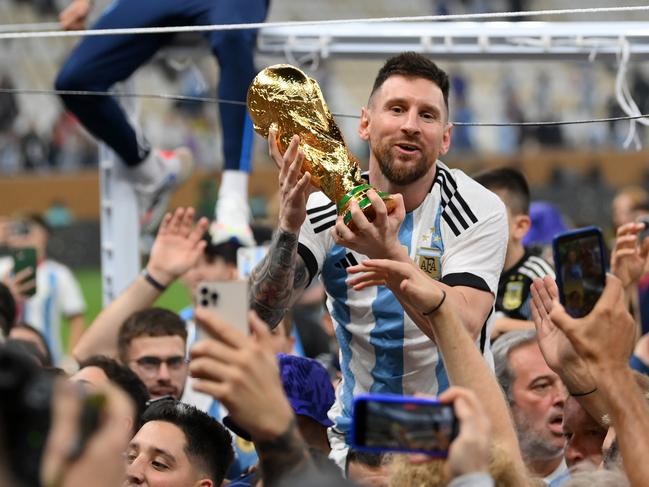 LUSAIL CITY, QATAR - DECEMBER 18: Lionel Messi of Argentina celebrates with the FIFA World Cup Qatar 2022 Winner's Trophy after the team's victory during the FIFA World Cup Qatar 2022 Final match between Argentina and France at Lusail Stadium on December 18, 2022 in Lusail City, Qatar. (Photo by Dan Mullan/Getty Images)