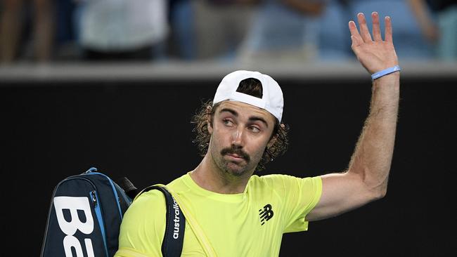 Australia's Jordan Thompson waves as he leave the court after losing his second round match to Italy's Fabio Fognini. Picture: AP