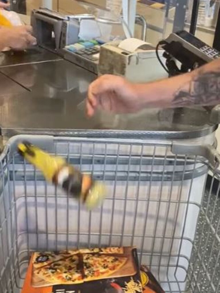 While she unloads the goods onto the counter from one trolley, her husband is at the end of the cashier with another trolley quickly sliding in the goods. Picture: Facebook/AldiMums