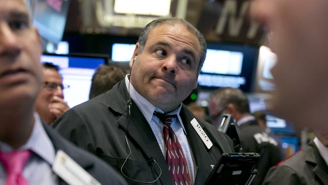 Trader Anthony Riccio works on the floor of the New York Stock Exchange Tuesday, Aug. 11, 2015. U.S. stocks opened lower on Tuesday, led by declines in energy and materials stocks as commodities prices dropped. Prices for oil and copper fell sharply after China's government lowered the value of its currency, suggesting weakness in the world's second-largest economy. (AP Photo/Richard Drew)