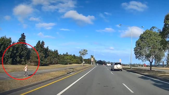 One of the children can be seen walking towards traffic.