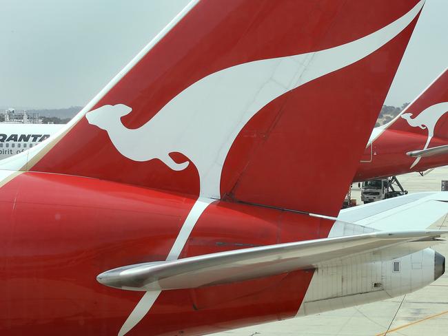 Qantas planes sit at their gates at Melbourne's Tullamarine Airport as the Qantas accepted an offer, 14 Dec 2006, to sell to a private equity group : AFP PicWilliam/West - industry aviation airlines aircraft plane logo logos flying kangaroo on tail companies