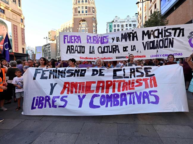 Protestors hold signs reading 'Rubiales and macho mafia out' and 'Feminist and anticapitalist, free and combative' during a demonstration called by feminist associations in support to Spain's midfielder Jenni Hermoso, in Madrid on August 28, 2023. A growing number of voices denounce the Spain's football federation president Luis Rubiales after his forced kiss on Jenni Hermoso's lips at women's World Cup final. Rubiales was provisionally suspended by FIFA for 90 days on August 26, and Spain's prosecutors opened a preliminary sex abuse probe on August 28. (Photo by OSCAR DEL POZO / AFP)