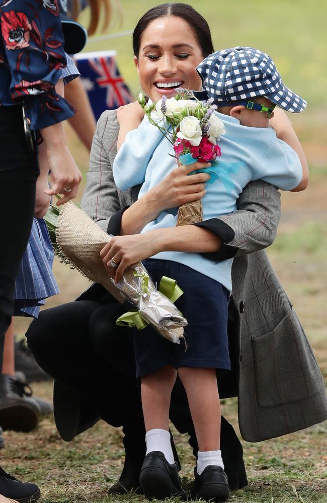 Luke gave the Duchess Of Sussex a big hug as well as a bunch of flowers. Picture: Matrix.