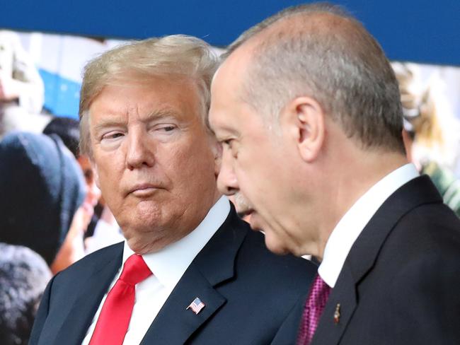 (FILES) In this file photo taken on July 11, 2018 US President Donald Trump (L) talks to Turkey’s President Recep Tayyip Erdogan (R) as they arrive for the NATO summit, at the NATO headquarters in Brussels. - Trump said on August 10, 2018, he had doubled steel and aluminum tariffs on Turkey, adding to pressure on that nation's troubled economy amid a diplomatic row with Washington. "I have just authorized a doubling of Tariffs on Steel and Aluminum with respect to Turkey as their currency, the Turkish Lira, slides rapidly downward against our very strong Dollar!" Trump said on Twitter. (Photo by Tatyana ZENKOVICH / POOL / AFP)