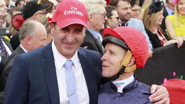 Jockey Kerrin McEvoy (right), with trainer Robert Hickmott, celebrate after Almandin wins the 2016 Melbourne Cup. Picture: AAP Images.