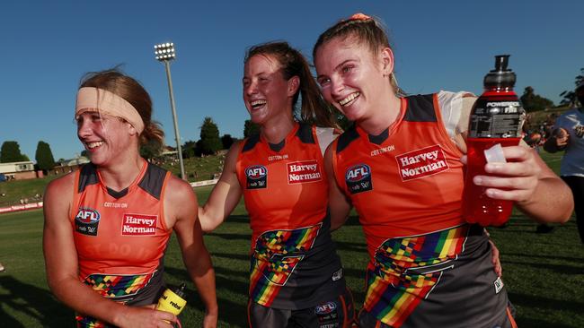 GWS Giants Katherine Smith, Nicola Barr and Lisa Steane of the Giants celebrate in their team’s LGBTQIA+ pride jerseys. Picture: Dylan Burns/AFL Photos via Getty Images