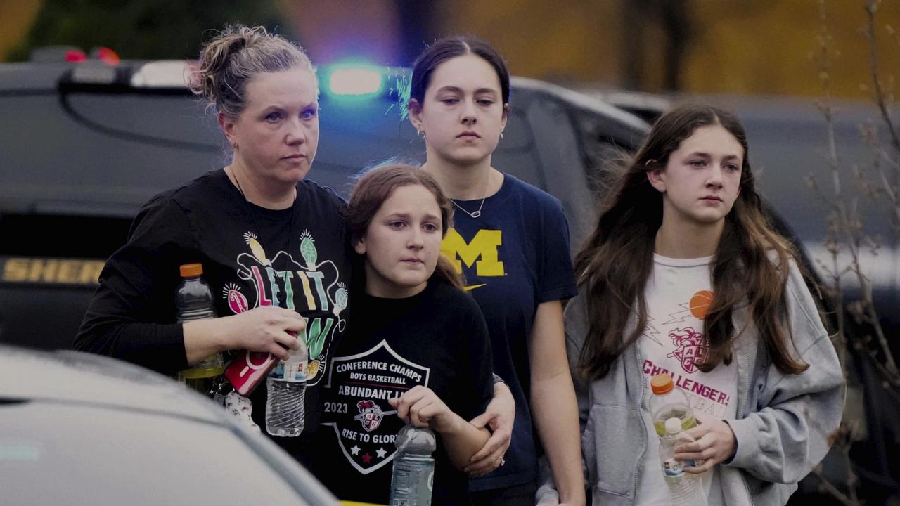 A family leave the shelter after multiple injuries were reported following a shooting. Picture: AFP/Morry Gash