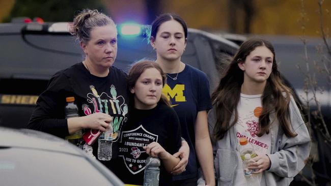 A family leave the shelter after multiple injuries were reported following a shooting. Picture: AFP/Morry Gash