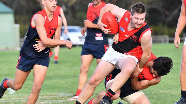 Morphett Vale’s Adrian Albanese tries to break free from Flagstaff Hill’s David Kearsley during a clash last year. Picture: AAP/ Keryn Stevens