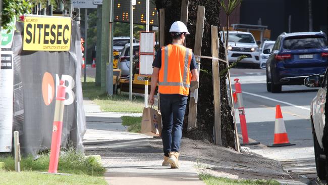 A worker arrives at the Shoreline tower construction site at 61 Old Burleigh Rd to find it locked up on Monday. Picture: Glenn Hampson