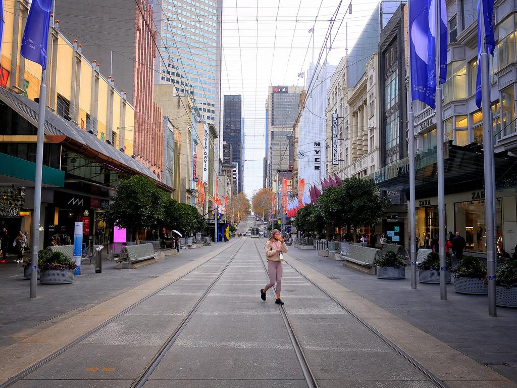 Commuters are seen walking around Melbourne CDB. Picture: Luis Enrique Ascui