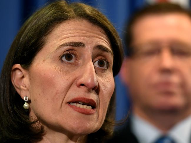 NSW Premier Gladys Berejiklian (left) and NSW Police Minister Troy Grant speak to the media  in Sydney, Tuesday, September 18, 2018. (AAP Image/Joel Carrett) NO ARCHIVING