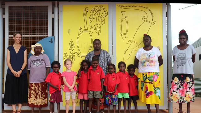 RAMINGINING SCHOOL: BUNBA (BUTTERFLY CLASS) . (L-R): Daisy Banaka (assistant teacher), Emily Lamrock (teacher), Kayla Durrurrnga, Noa Techand, Hekelia Garawirrtja, Saul Garrawurra, Melissa Gaykamangu (mother), Nicole Bonson, Natasha Guyula, Matrayson Lee, Doreen Bilpil (mother), Narelle Bonson (grandmother)