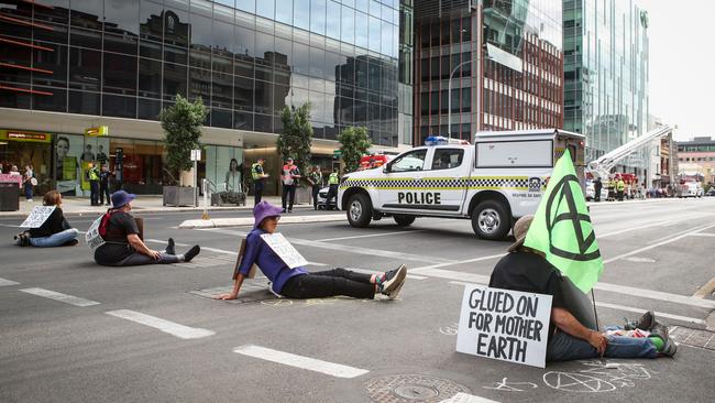 Protesters with their hands glued to the road near Santos headquarters, 60 Flinders Street on March 10, 2020 in Adelaide. Picture: Matt Turner.