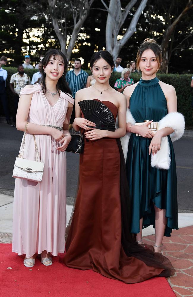 Elizabeth Loo, Carrie Qu and Yaya Fischer at Centenary Heights State High School formal. Picture; Patrick Woods.