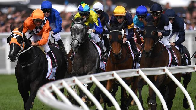 Ben Melham rides Homesman (second from right), navy blue and white silks) in race eight, the Caulfield Cup during the Stella Artois Caulfield Cup Day at Caulfield Racecourse in Melbourne, Saturday, October 20, 2018. The race winner, Pat Cosgrave riding Best Solution is seen at second from left. (AAP Image/Julian Smith) NO ARCHIVING, EDITORIAL USE ONLY