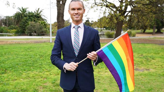 Deputy Mayor of Moonee Valley, Cam Nation, proudly waves the rainbow flag after council's recent endorsement of marriage equality in Australia.