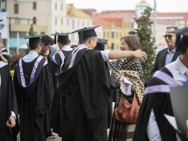 Michell Tan hugs his mother Patricia Chew. UTAS graduations. School of College of Health and Medicine Graduate Research. Picture: RICHARD JUPE