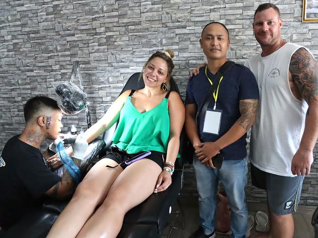 Nyoman Wira Adi Budiawan (centre, right), the owner of Good Life Tattoo, is donating 50 per cent of the purchase of every tattoo to the NSW Rural Fire Service until the end of February. Picture: Lukman S. Bintoro