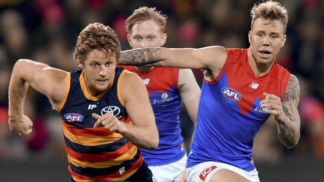 Rory Sloane and James Harmes chase the ball.