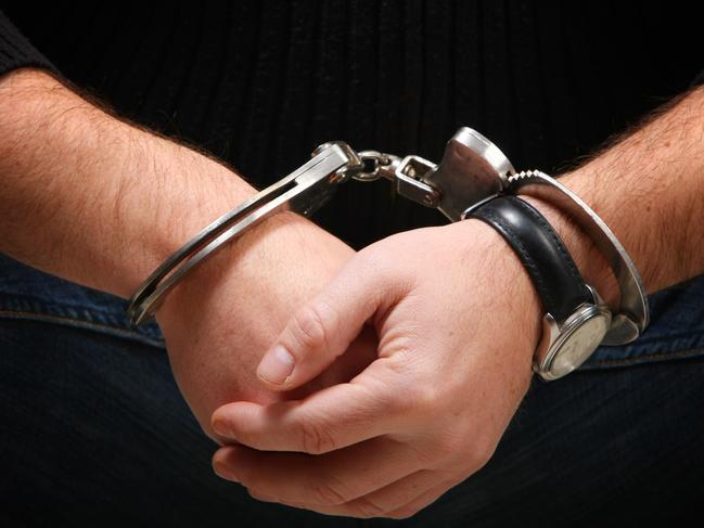 Busted - Man wearing handcuffs Source : Thinkstock