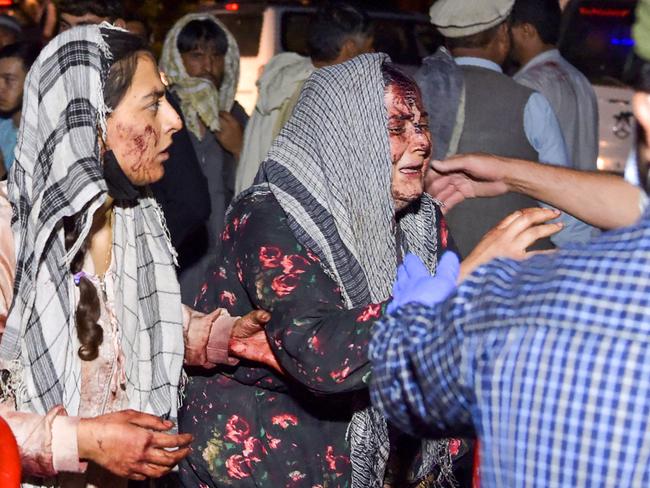 Wounded women arrive at a hospital for treatment after two terror blasts outside the airport in Kabul on August 26. Picture: AFP