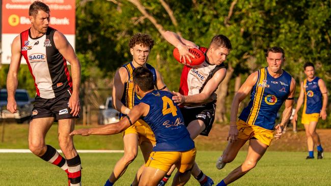 Brandon Rusca of Southern Districts caught in a tackle against Wanderers in Round 2 of the 2022-23 NTFL season. Picture: David Bradley / AFLNT Media