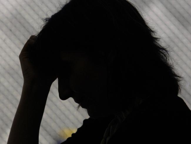 Silhouette of woman stressed and upset, crying.