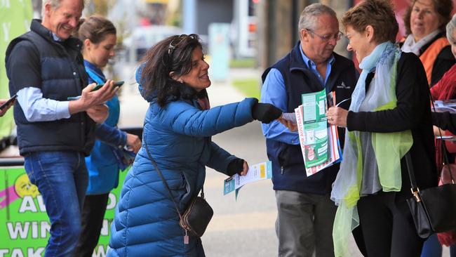 Hold on: Independent Julia Banks, busy handing out her flyers, doesn’t want to miss this voter in Rosebud on a chilly day. Picture: Aaron Francis