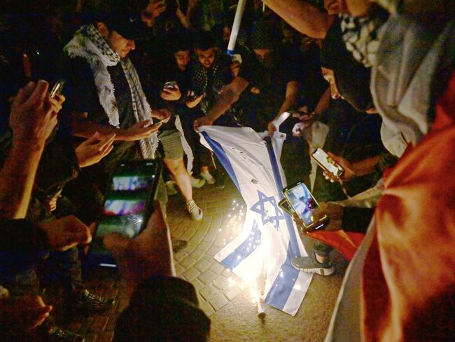 SYDNEY, AUSTRALIA - NewsWire Photos OCTOBER 9, 2023: ÃRally For A Free PalestineÃ protest burn the Israeli flag on the forecourt of The Sydney Opera House in Sydney following the recent outbreak of war between Israel and Palestine. Picture: NCA NewsWire / Jeremy Piper